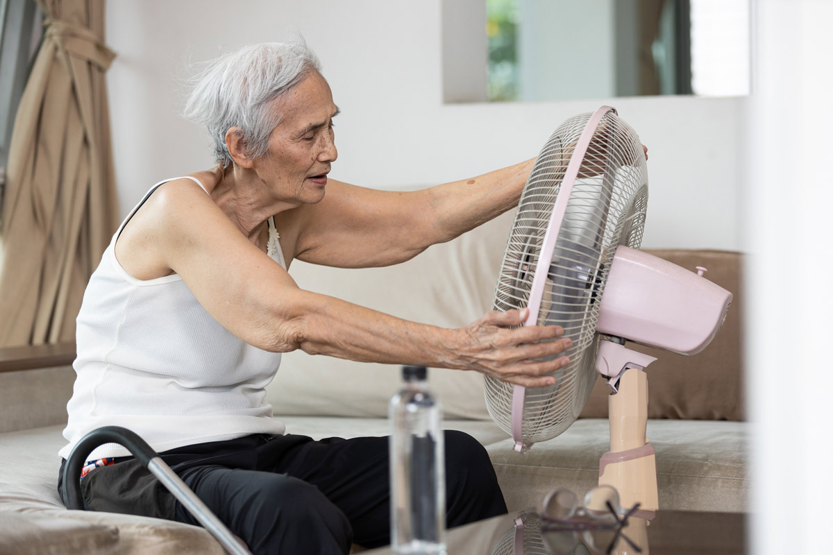 Overheated asian senior woman sweating,high temperature in sunny